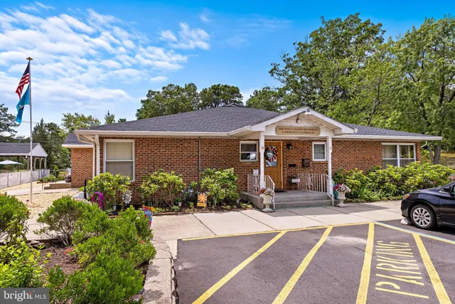a view of patio with chairs and table under an umbrella
