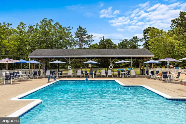 a wooden bench sitting in the middle of a yard