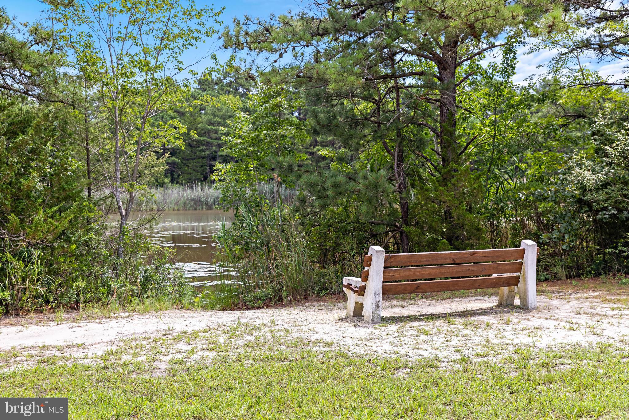 37 Fir Road Manahawkin, NJ 08050 - Photo 38 of 40 a wooden bench sitting in the middle of a yard