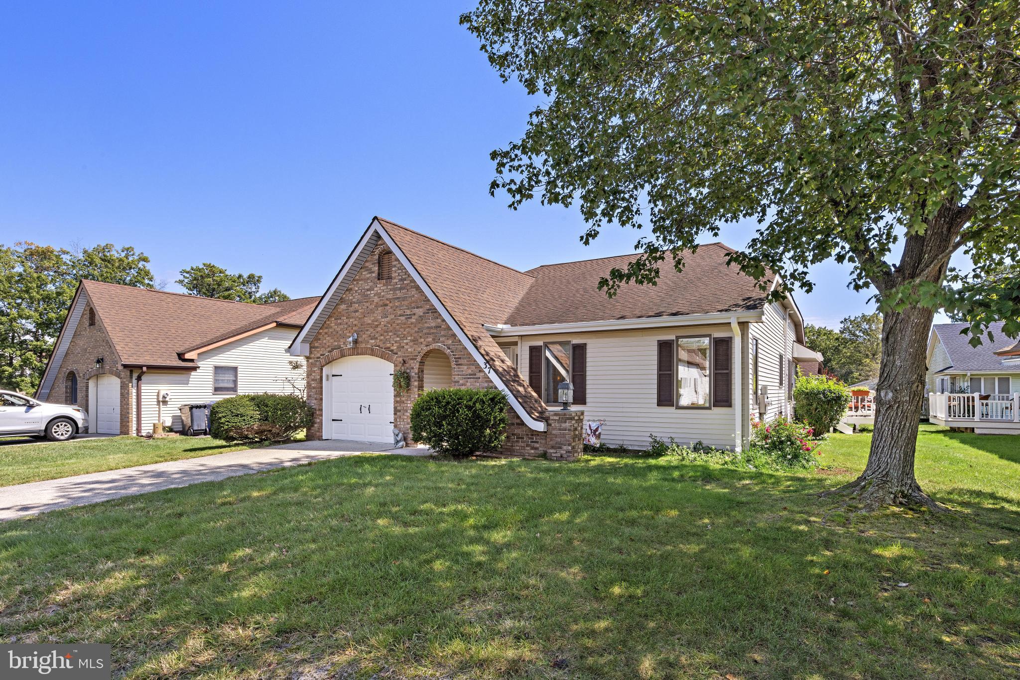 37 Fir Road Manahawkin, NJ 08050 - Photo 4 of 40 a front view of a house with garden