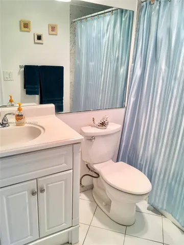 a bathroom with a sink a toilet and vanity