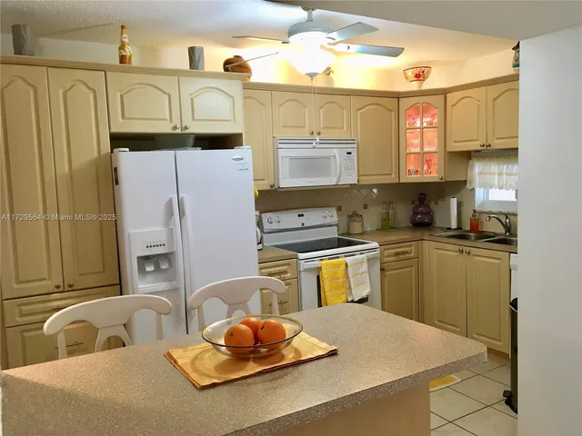 a kitchen with stainless steel appliances granite countertop a sink and cabinets