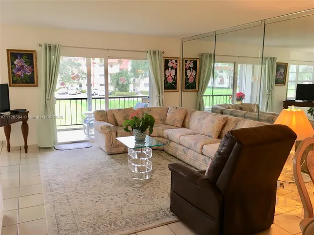 a living room with furniture and large windows