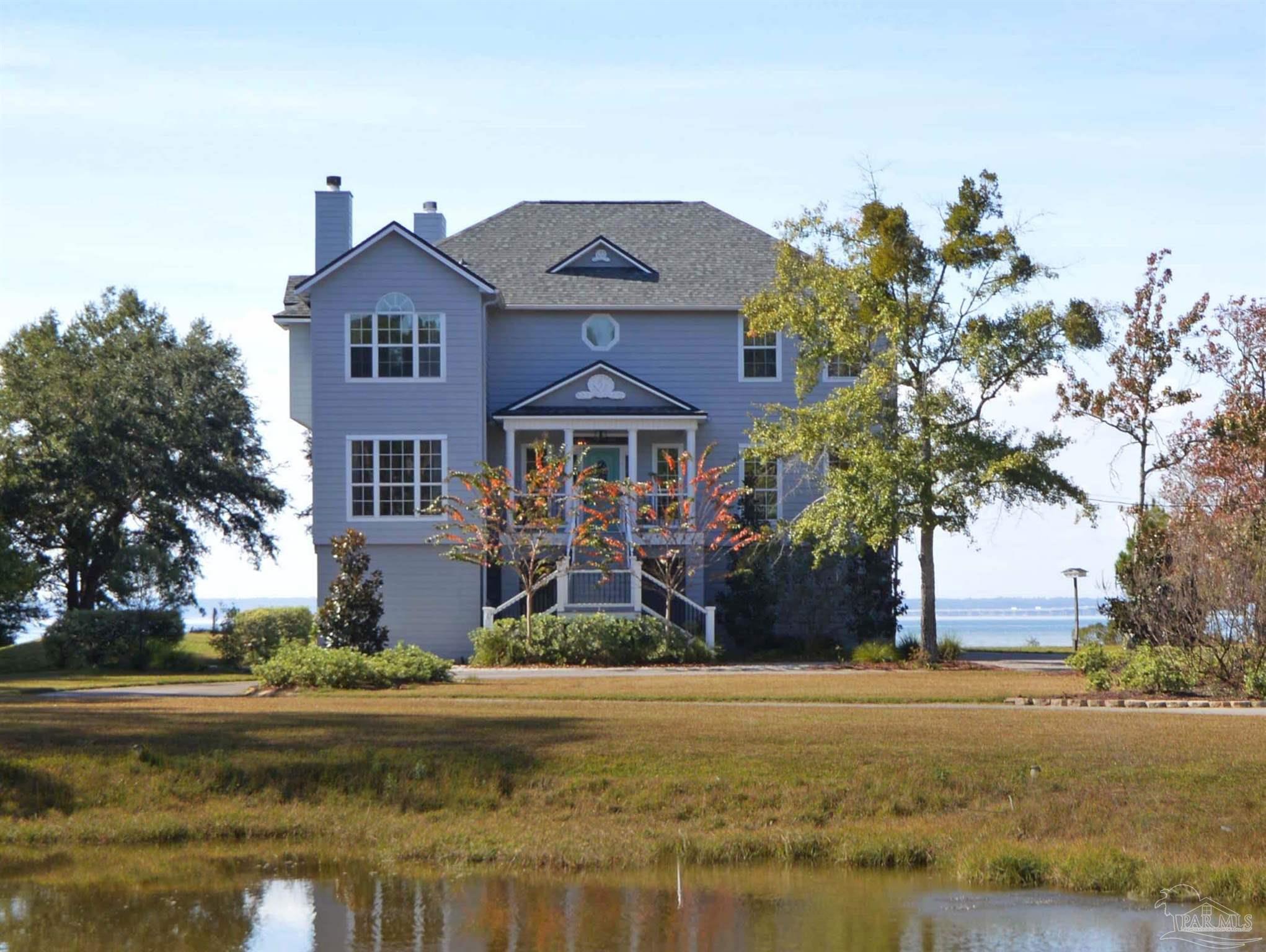 a front view of a house with a yard and a garage