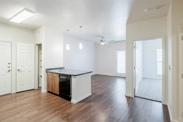 a view of an empty room with wooden floor