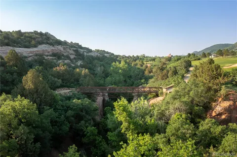 an aerial view of mountain with trees around