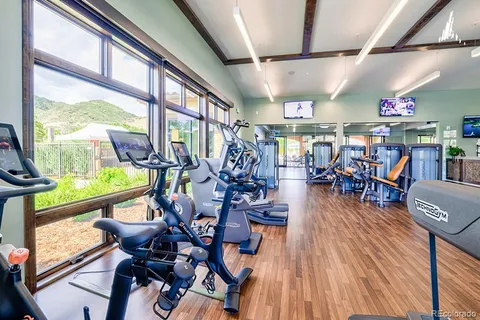 a room with lots of wooden furniture and large windows