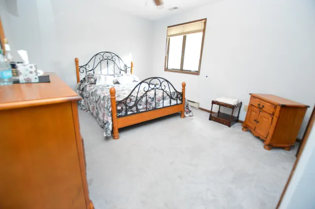 a bed sitting in a bedroom next to a window