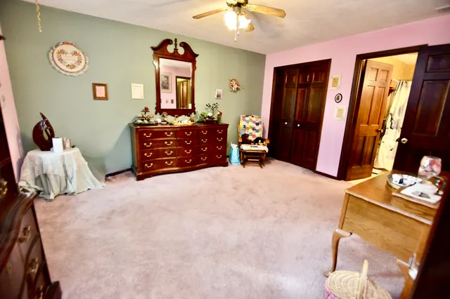 a bedroom with a bed and a mirror on dresser