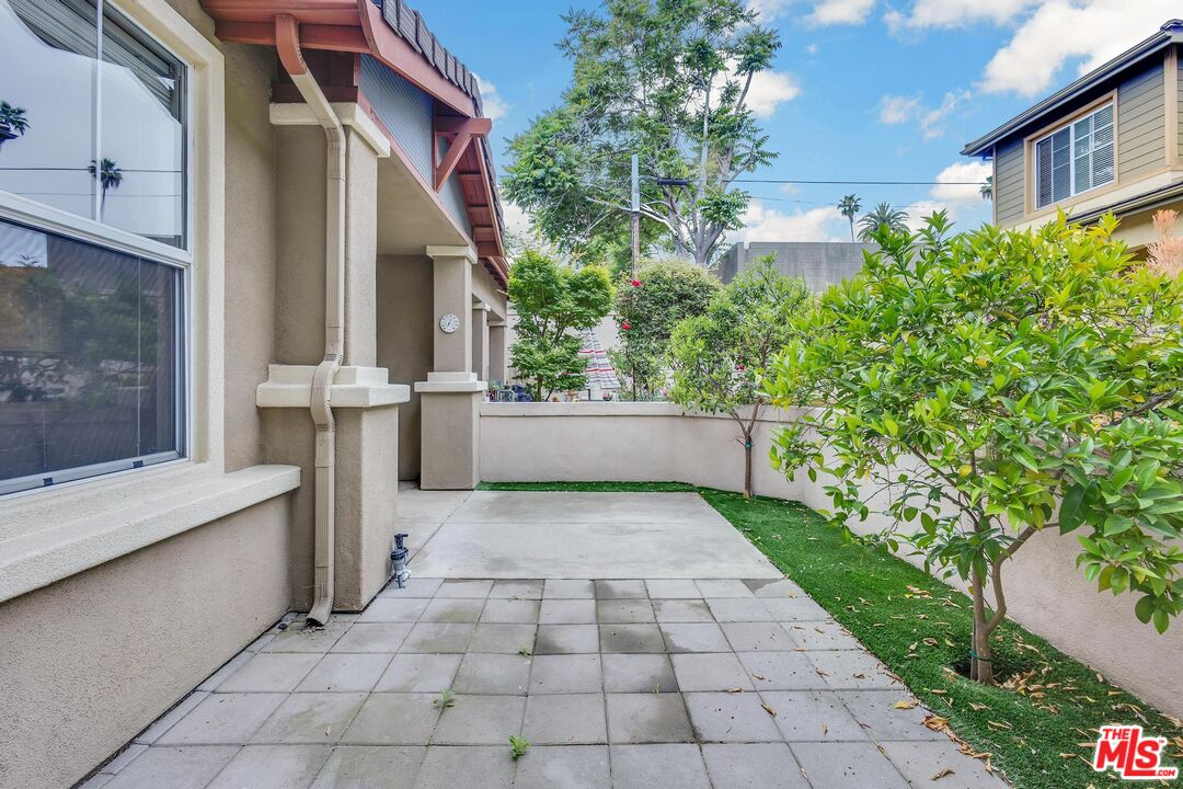 1131 Rosewalk Way Pasadena, CA 91103 - Photo 15 of 42 a view of a white house with a small yard and plants