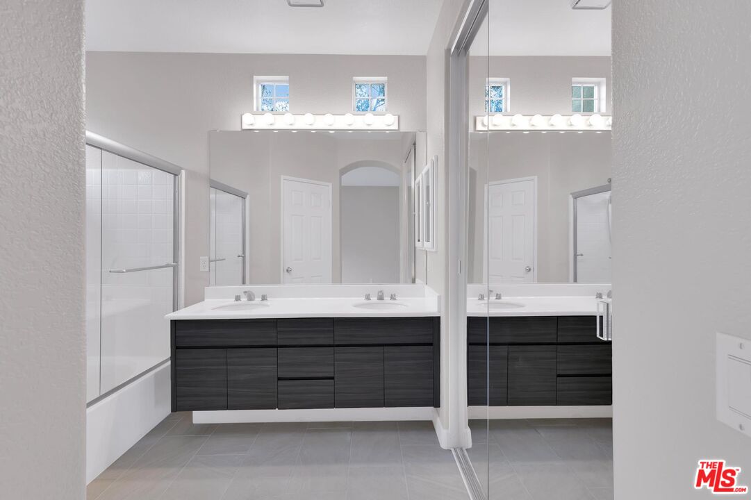 1131 Rosewalk Way Pasadena, CA 91103 - Photo 27 of 42 a bathroom with double vanity sinks and a mirror