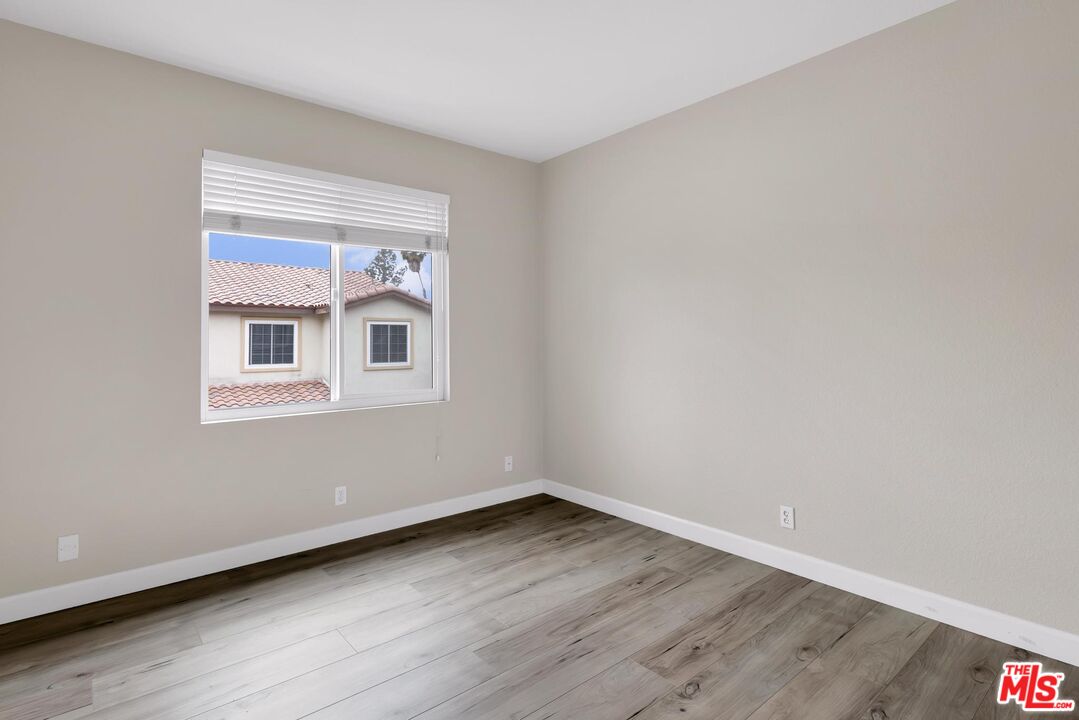 1131 Rosewalk Way Pasadena, CA 91103 - Photo 32 of 42 a view of an empty room with wooden floor and a window