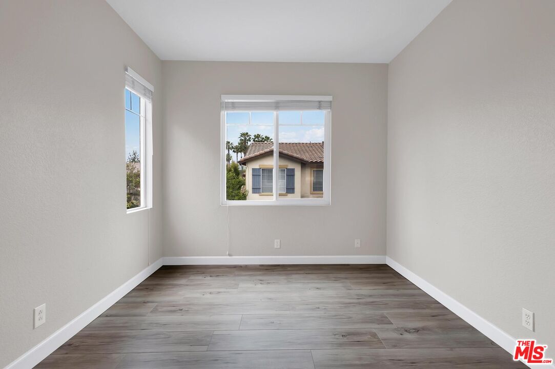 1131 Rosewalk Way Pasadena, CA 91103 - Photo 35 of 42 a view of an empty room with wooden floor and a window