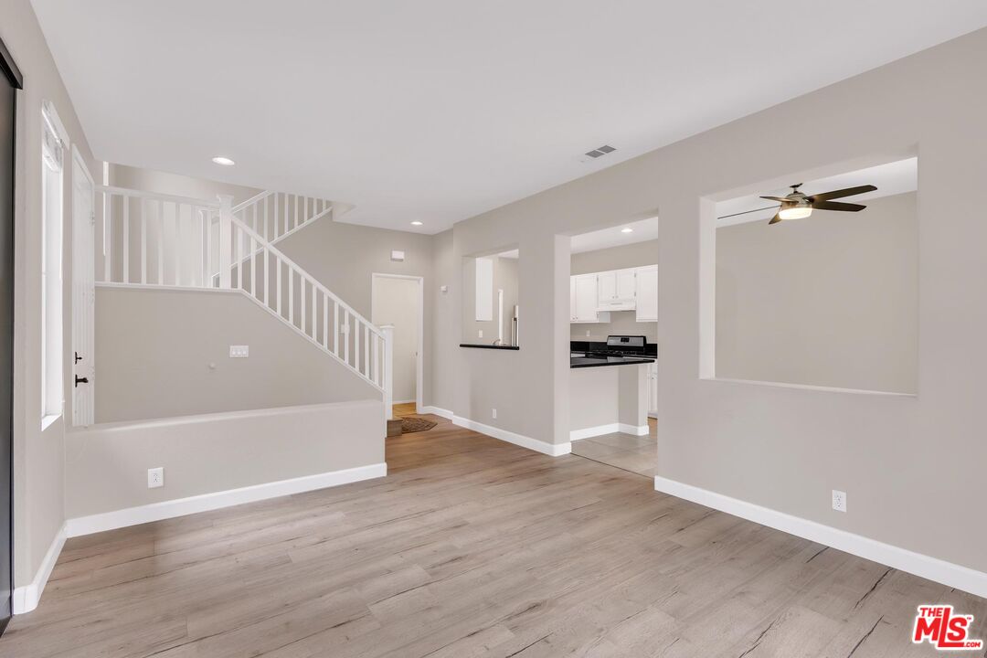 1131 Rosewalk Way Pasadena, CA 91103 - Photo 6 of 42 a view of an empty room and kitchen with wooden floor