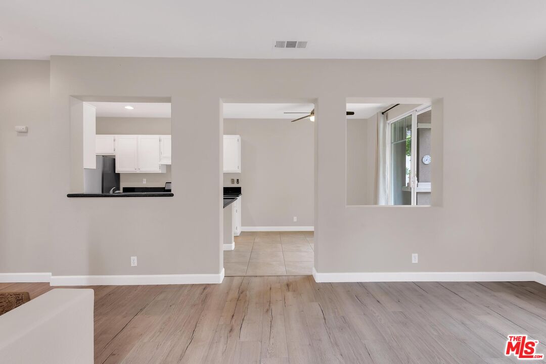 1131 Rosewalk Way Pasadena, CA 91103 - Photo 7 of 42 a view of an empty room with wooden floor and a bathroom