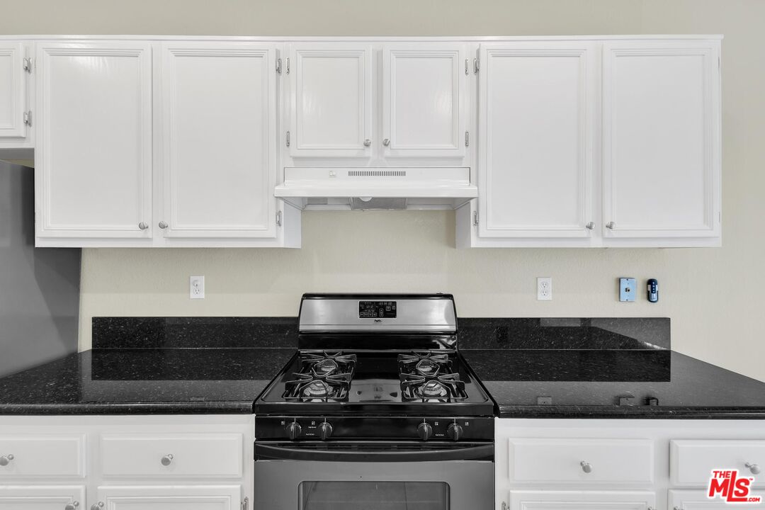 1131 Rosewalk Way Pasadena, CA 91103 - Photo 10 of 42 a kitchen with granite countertop white cabinets and stainless steel appliances