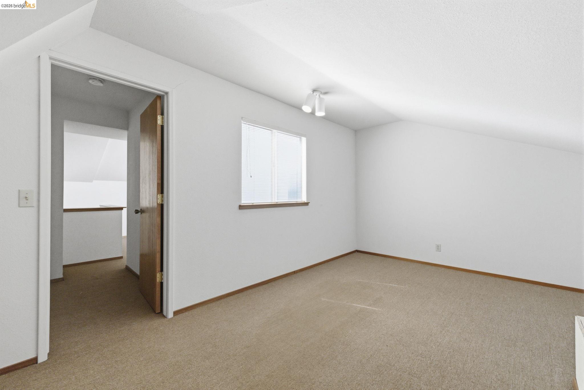 23685 Marble Quarry Road, Unit 8 Columbia, CA 95310 - Photo 13 of 25 an empty room with windows and closet