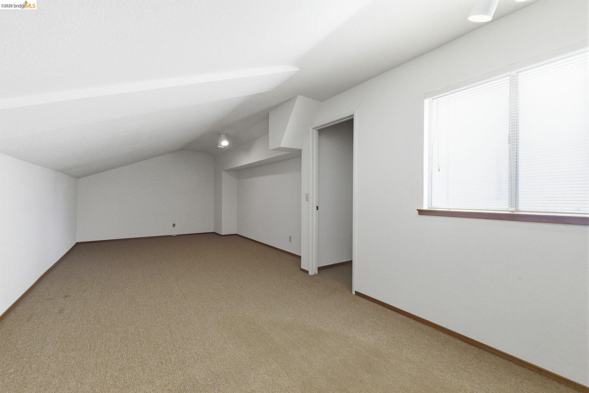 23685 Marble Quarry Road, Unit 8 Columbia, CA 95310 - Photo 14 of 25 an empty room with a empty space and windows