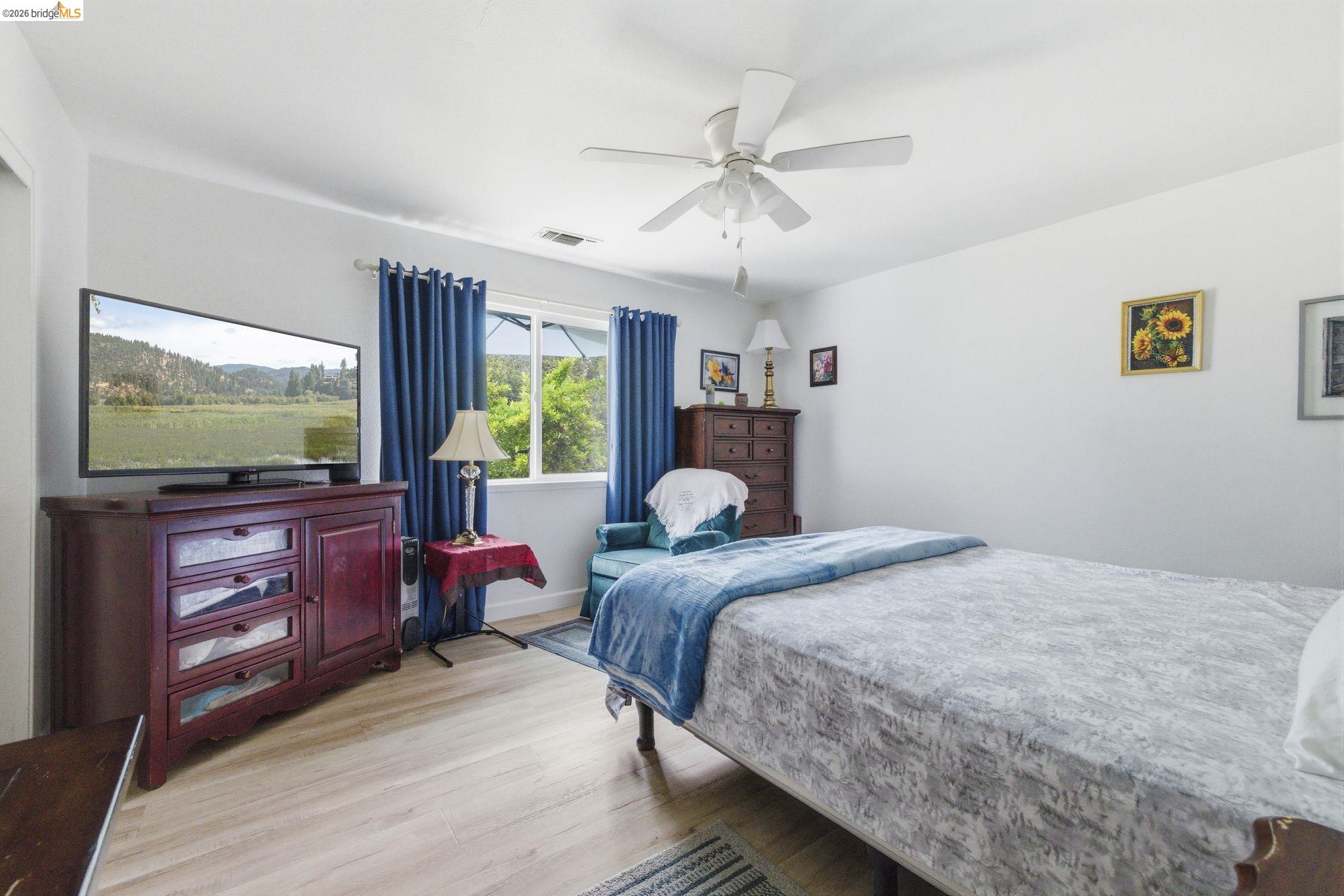 23685 Marble Quarry Road, Unit 8 Columbia, CA 95310 - Photo 16 of 25 a bedroom with a bed and a flat screen tv