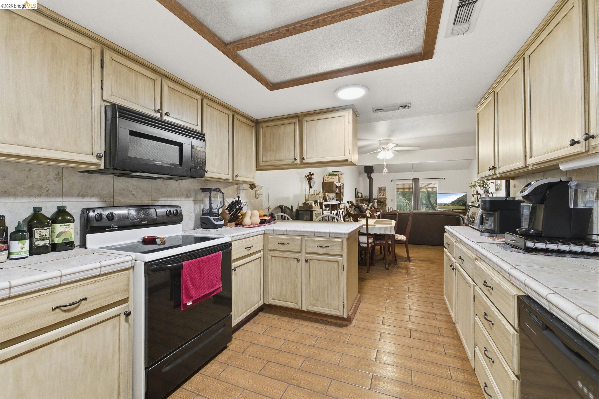 23685 Marble Quarry Road, Unit 8 Columbia, CA 95310 - Photo 7 of 25 a kitchen with stainless steel appliances granite countertop a stove sink microwave and cabinets