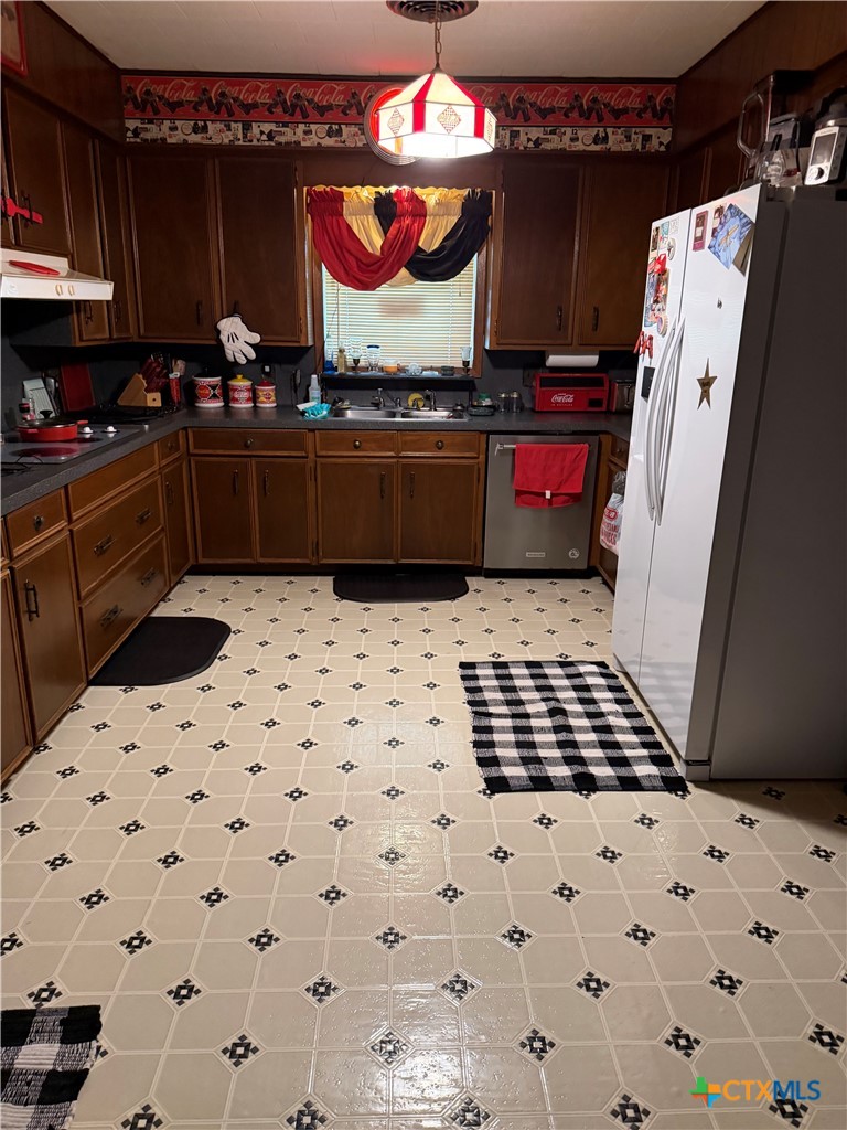57 John Tillery Road Port Lavaca, TX 77979 - Photo 24 of 34 a kitchen with granite countertop a stove and a refrigerator
