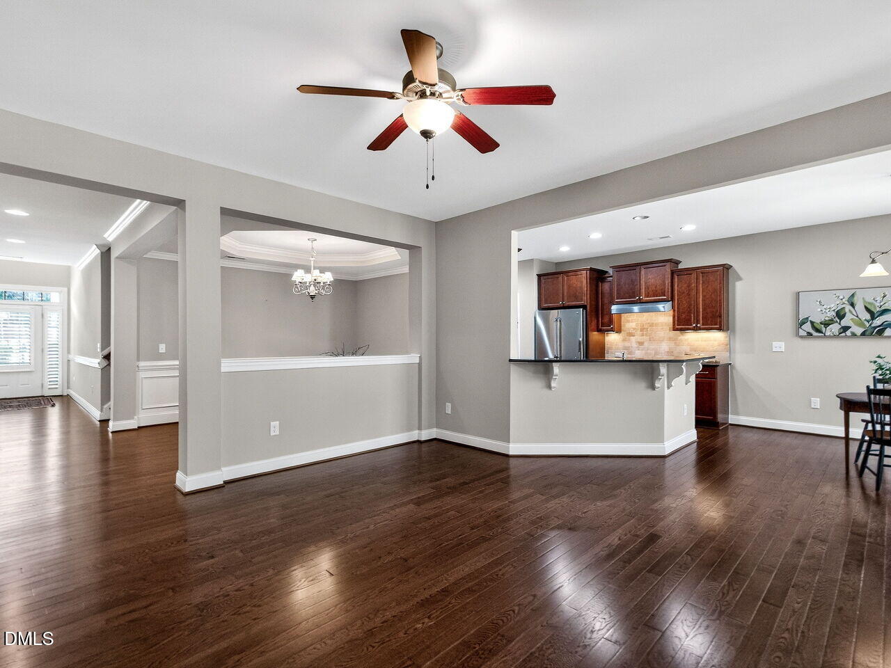 722 Toms Creek Road Cary, NC 27519 - Photo 11 of 42 a view of a livingroom with furniture wooden floor and a ceiling fan
