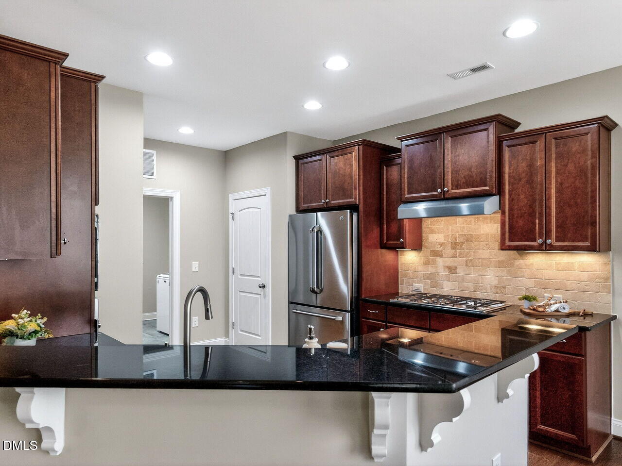 722 Toms Creek Road Cary, NC 27519 - Photo 13 of 42 a kitchen with kitchen island granite countertop a sink and refrigerator