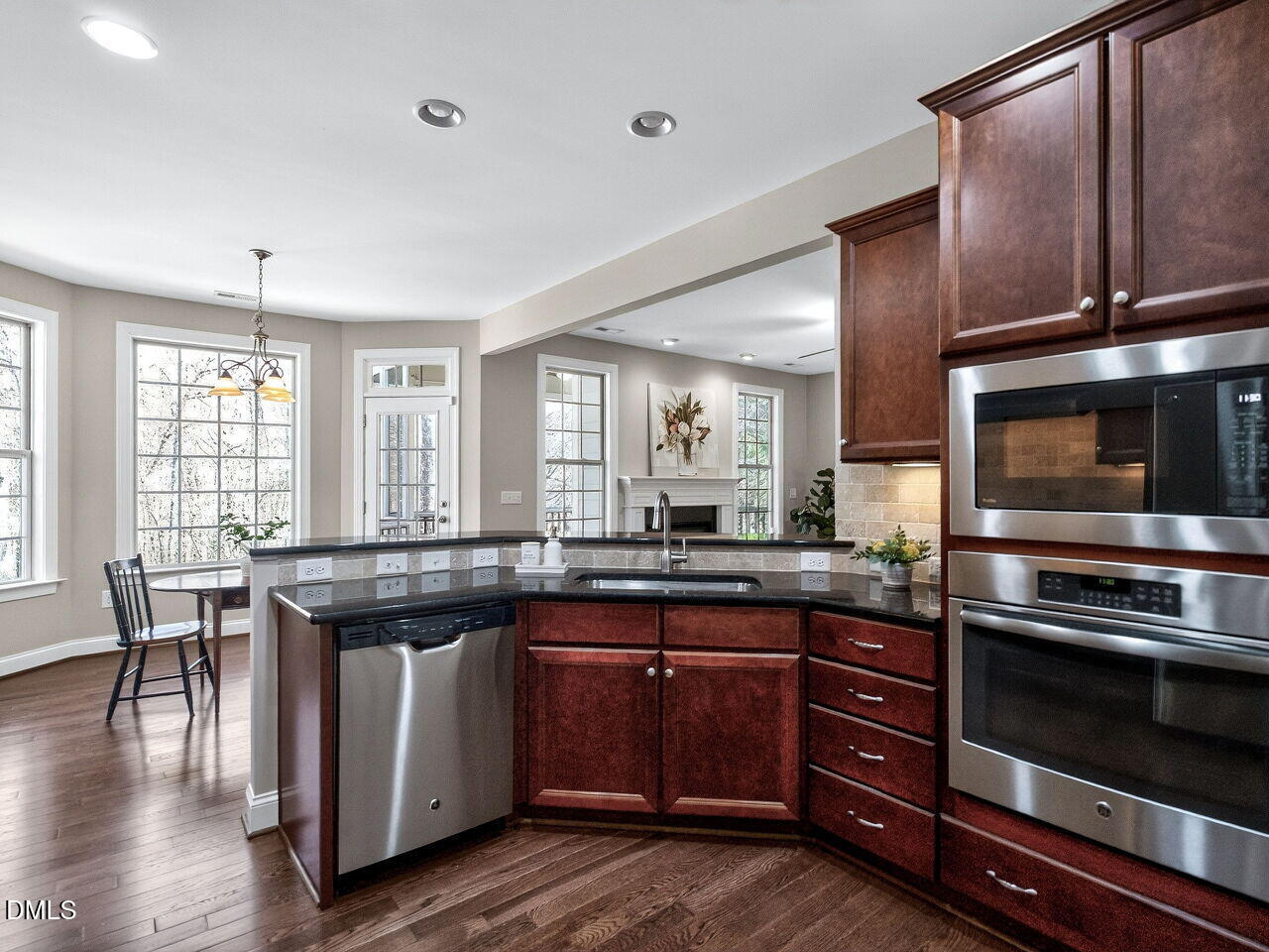 722 Toms Creek Road Cary, NC 27519 - Photo 14 of 42 a kitchen with granite countertop stainless steel appliances and wooden cabinets
