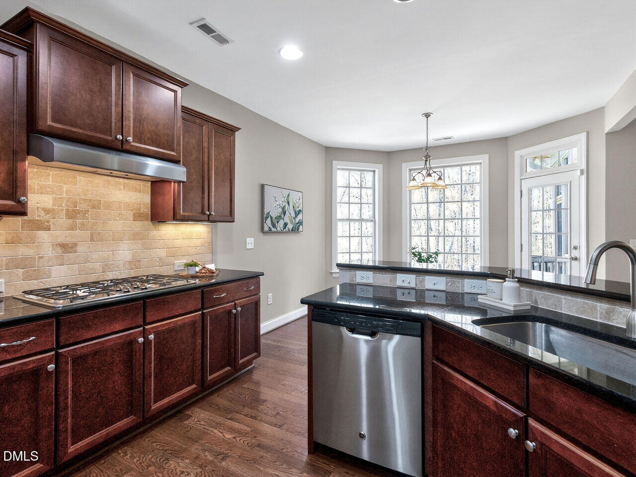 722 Toms Creek Road Cary, NC 27519 - Photo 16 of 42 a kitchen with granite countertop stainless steel appliances a sink stove and cabinets