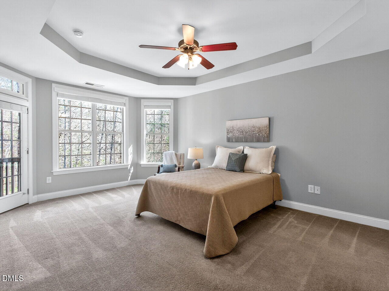 722 Toms Creek Road Cary, NC 27519 - Photo 18 of 42 a spacious bedroom with a bed and a large window