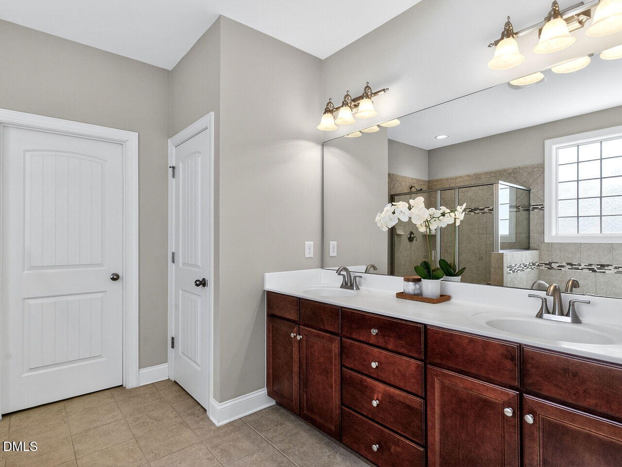 722 Toms Creek Road Cary, NC 27519 - Photo 19 of 42 a bathroom with a double vanity sink and a mirror