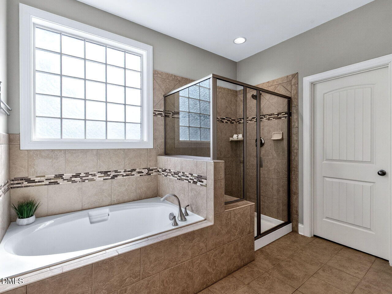 722 Toms Creek Road Cary, NC 27519 - Photo 20 of 42 a bathroom with a tub a sink and a shower