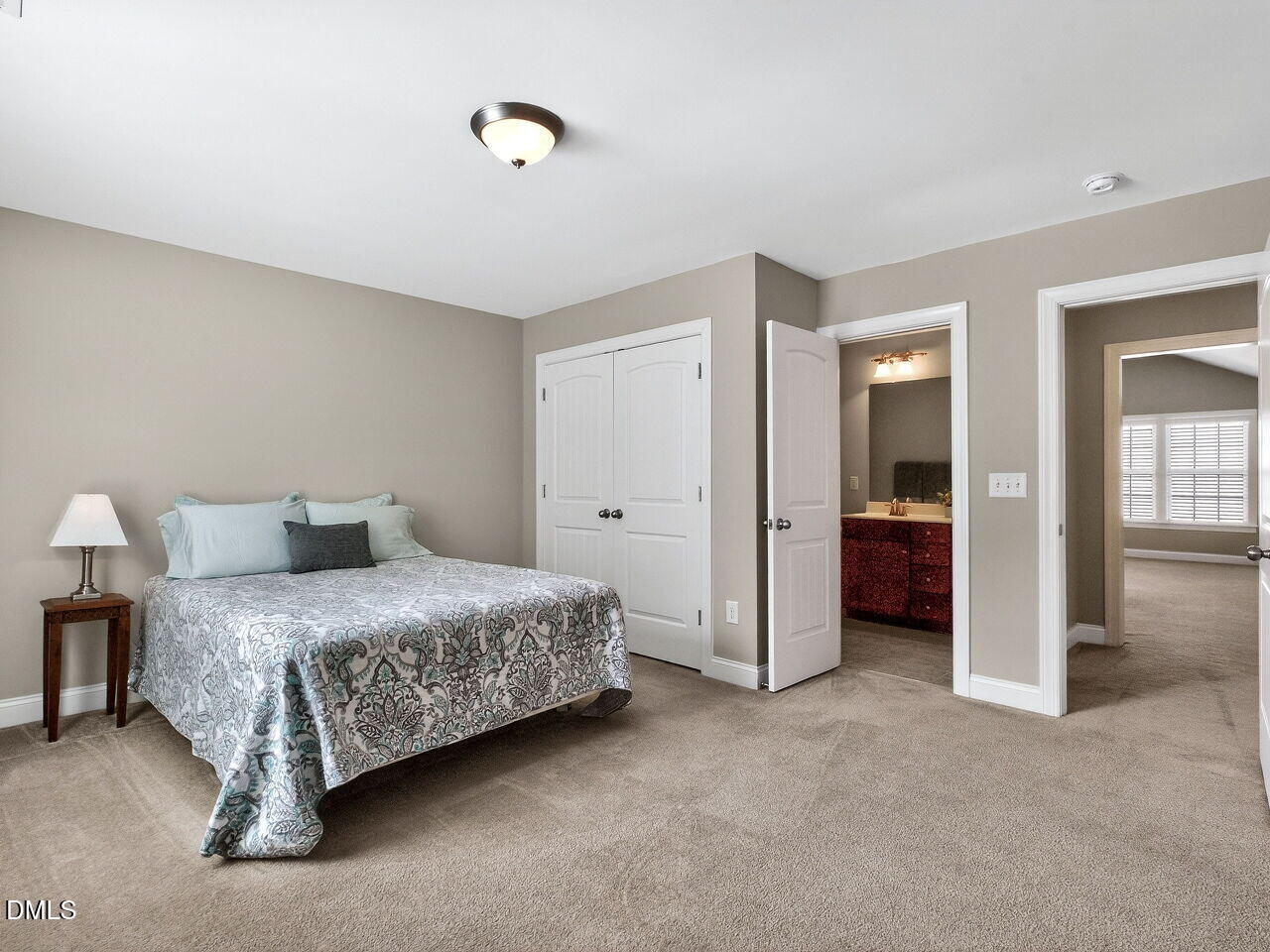 722 Toms Creek Road Cary, NC 27519 - Photo 27 of 42 a spacious bedroom with a bed and a lamp