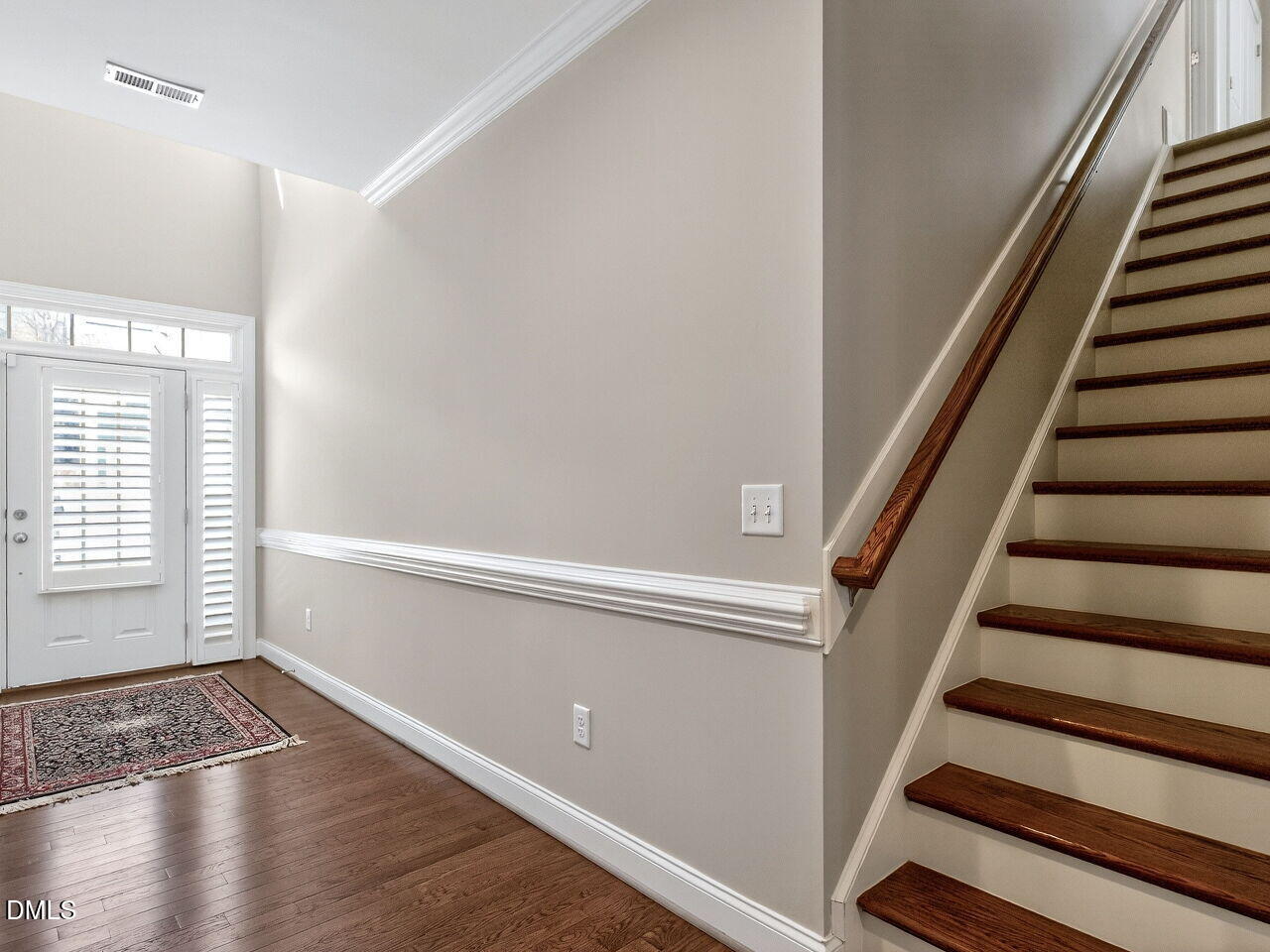 722 Toms Creek Road Cary, NC 27519 - Photo 6 of 42 a view of an empty room with wooden floor and stairs