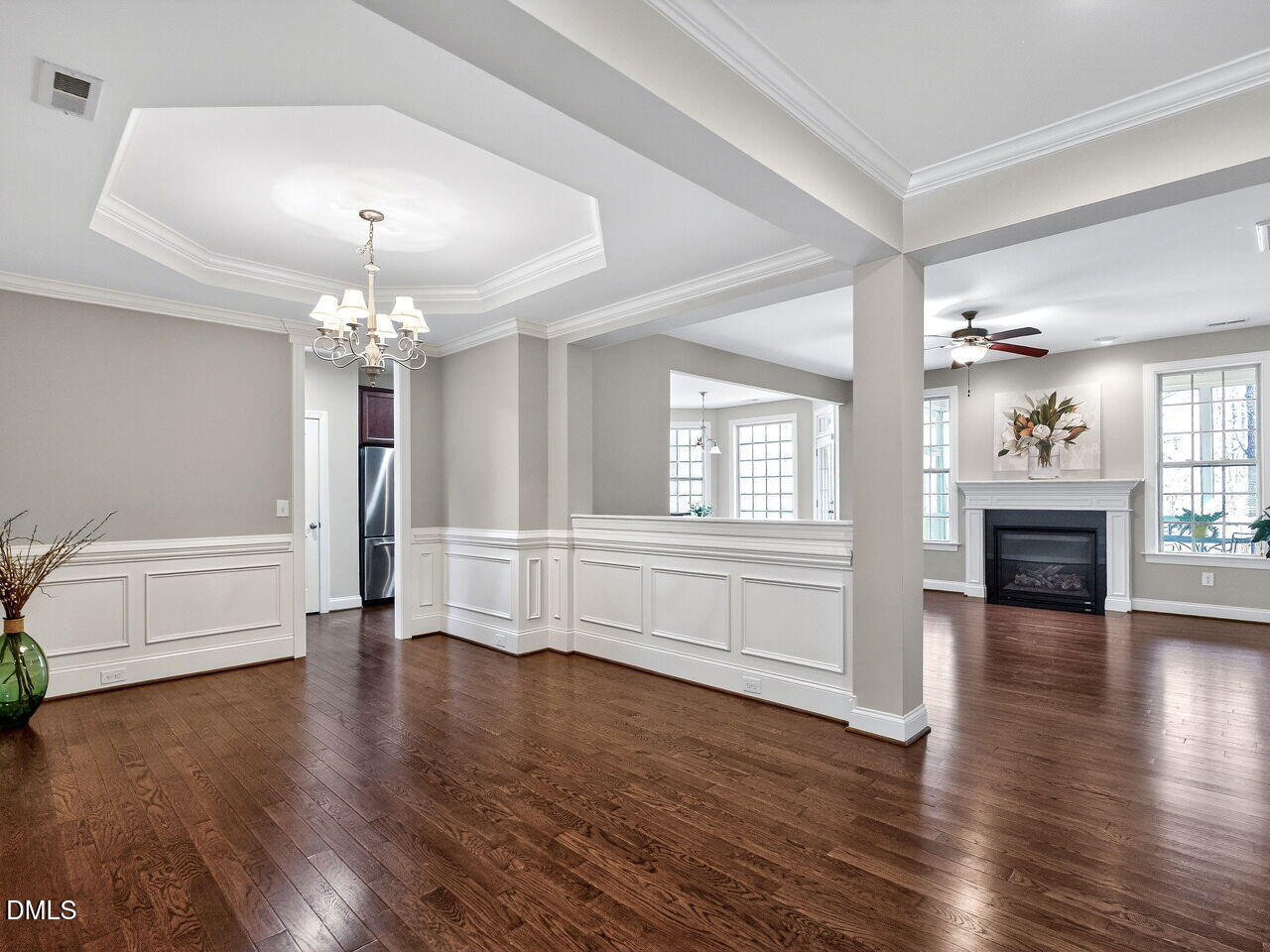 722 Toms Creek Road Cary, NC 27519 - Photo 7 of 42 an empty room with wooden floor fireplace and windows