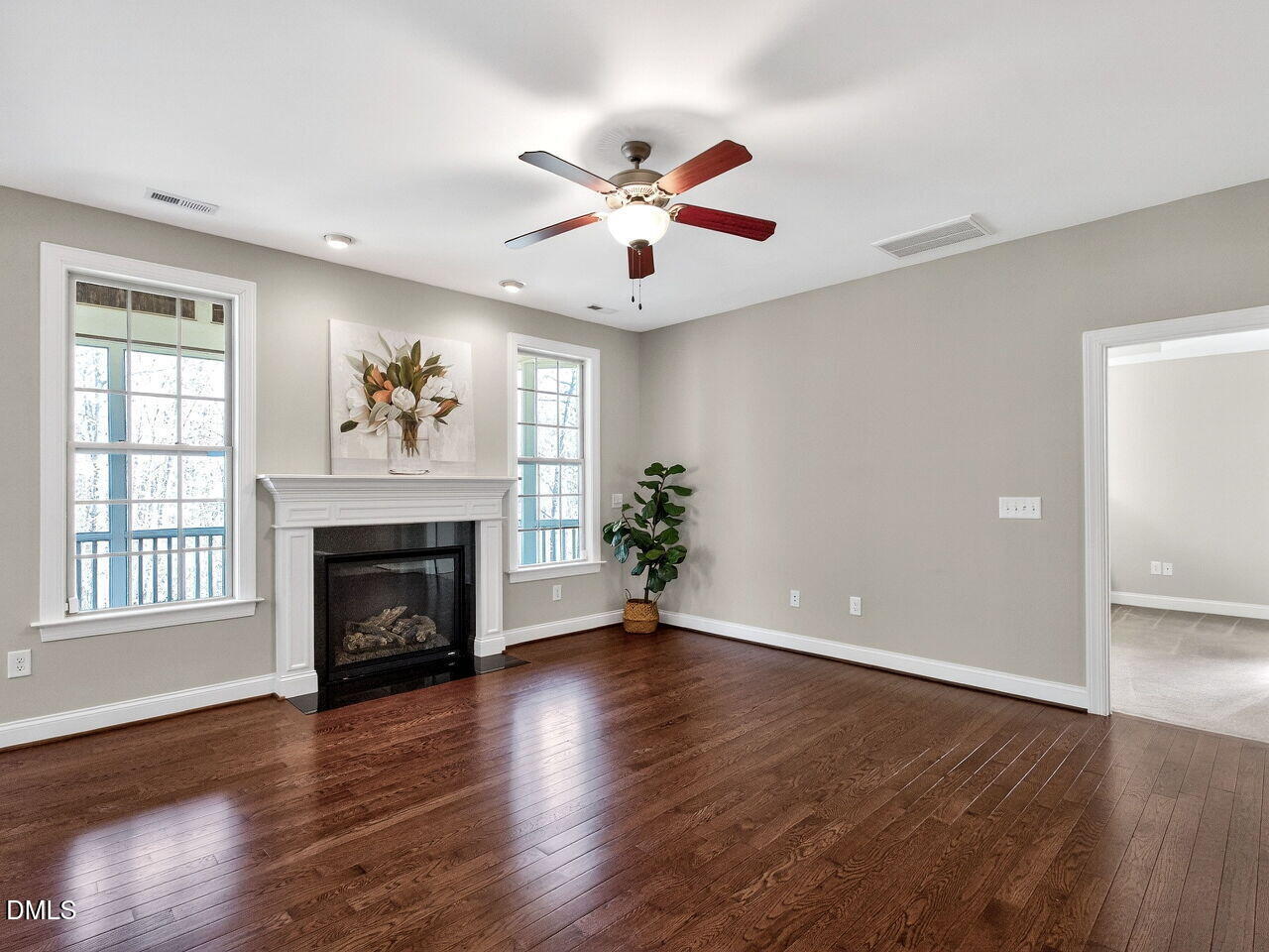 722 Toms Creek Road Cary, NC 27519 - Photo 9 of 42 a view of an empty room with wooden floor and a window