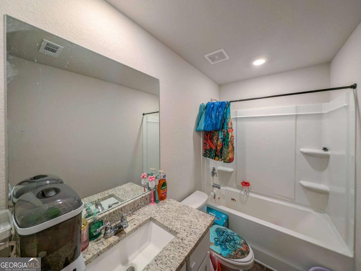 653 Meadows Farm Way Monroe, GA 30655 - Photo 31 of 34 a bathroom with a bathtub sink and shower