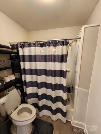 a bathroom with a toilet and a shower