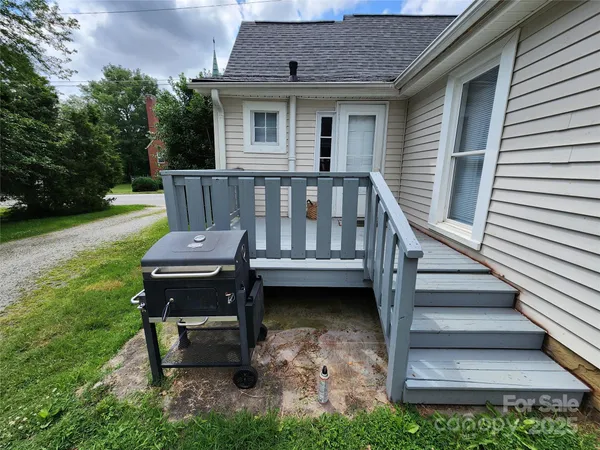 a view of a chair and table in backyard of the house
