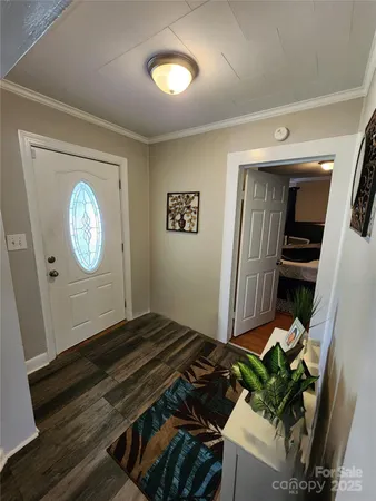 a living room with wooden floor furniture and a window