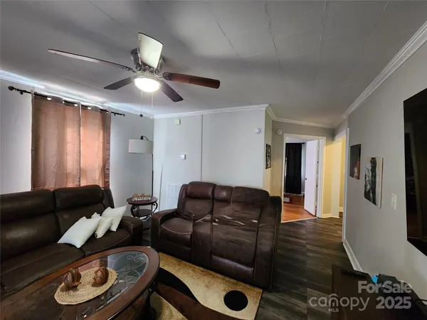 a living room with furniture and wooden floor