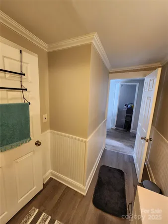 a view of a livingroom with wooden floor and staircase