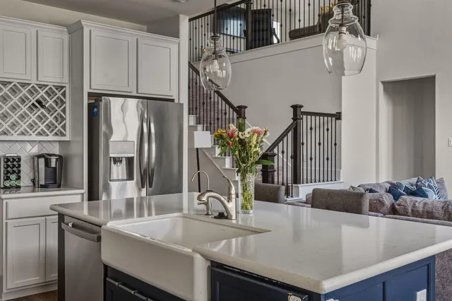 a kitchen with stainless steel appliances granite countertop a sink a refrigerator and a stove