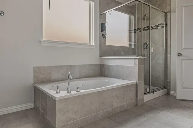 a bathroom with a tub and shower