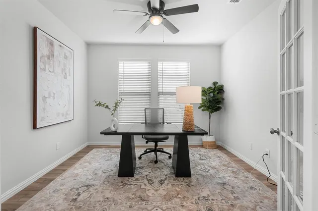 a view of a workspace with furniture and a window