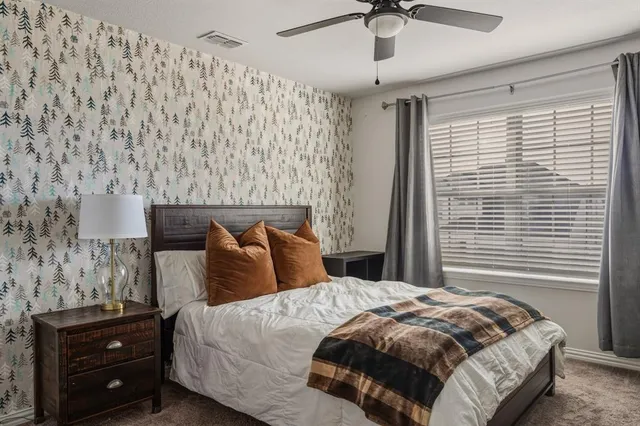 a bedroom with a bed and a chandelier