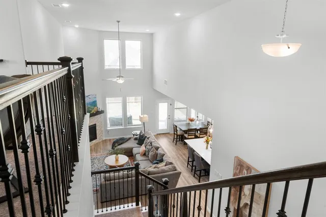 a view of a hallway with couches and chandelier