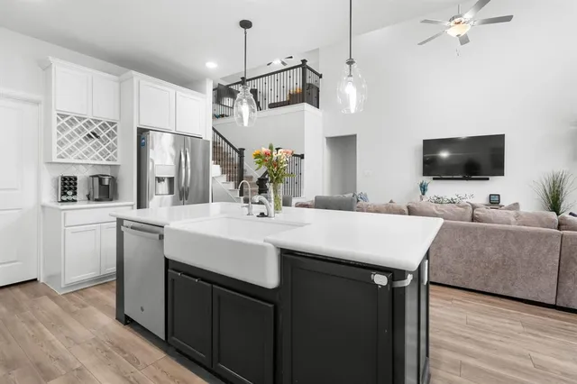 a view of kitchen island stainless steel appliances kitchen island a sink and a television