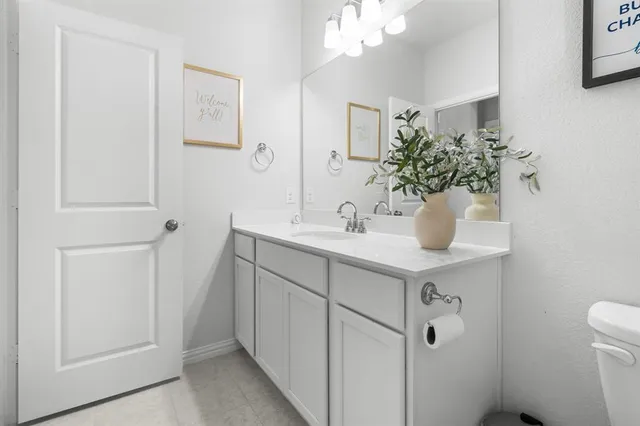 a bathroom with a sink a toilet and mirror