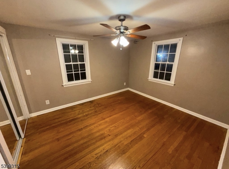 610 Lindegar Street Linden, NJ 07036 - Photo 5 of 8 a view of an empty room with wooden floor and a window